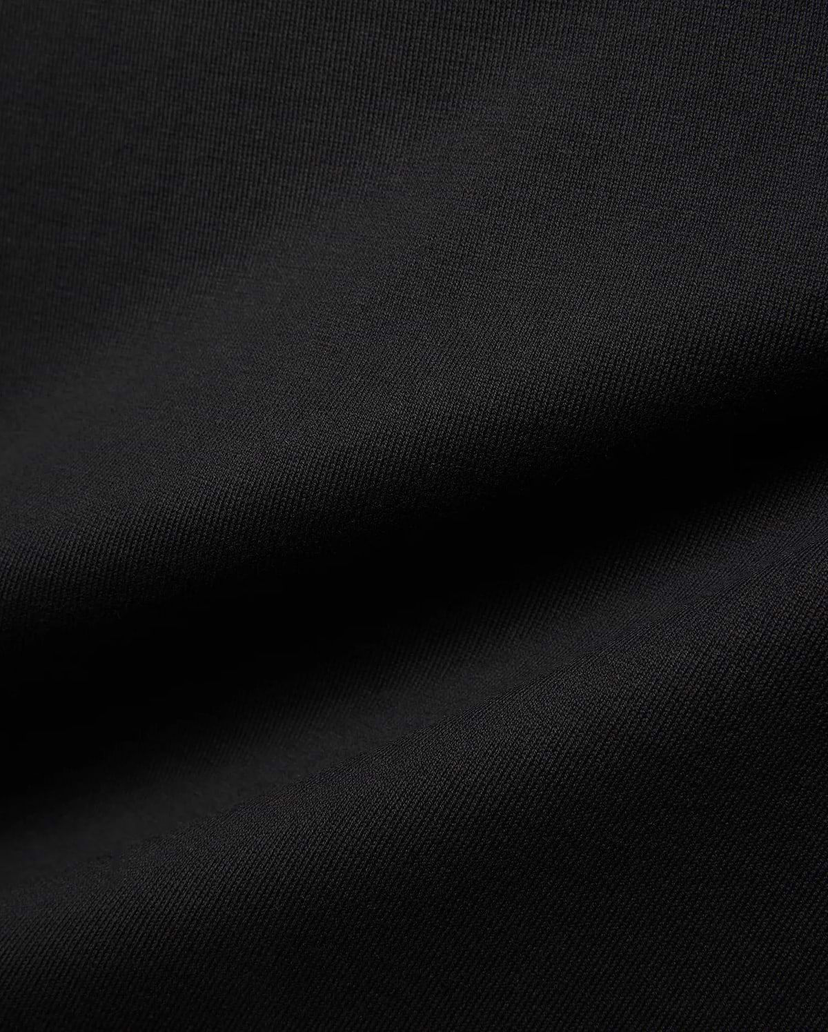 Mens Jaydon Relaxed Fit Tee in deep black, crafted from a premium, soft-touch jersey knit fabric with a subtle, refined texture, embodying Psycho Bunny's signature comfortable streetwear aesthetic.
