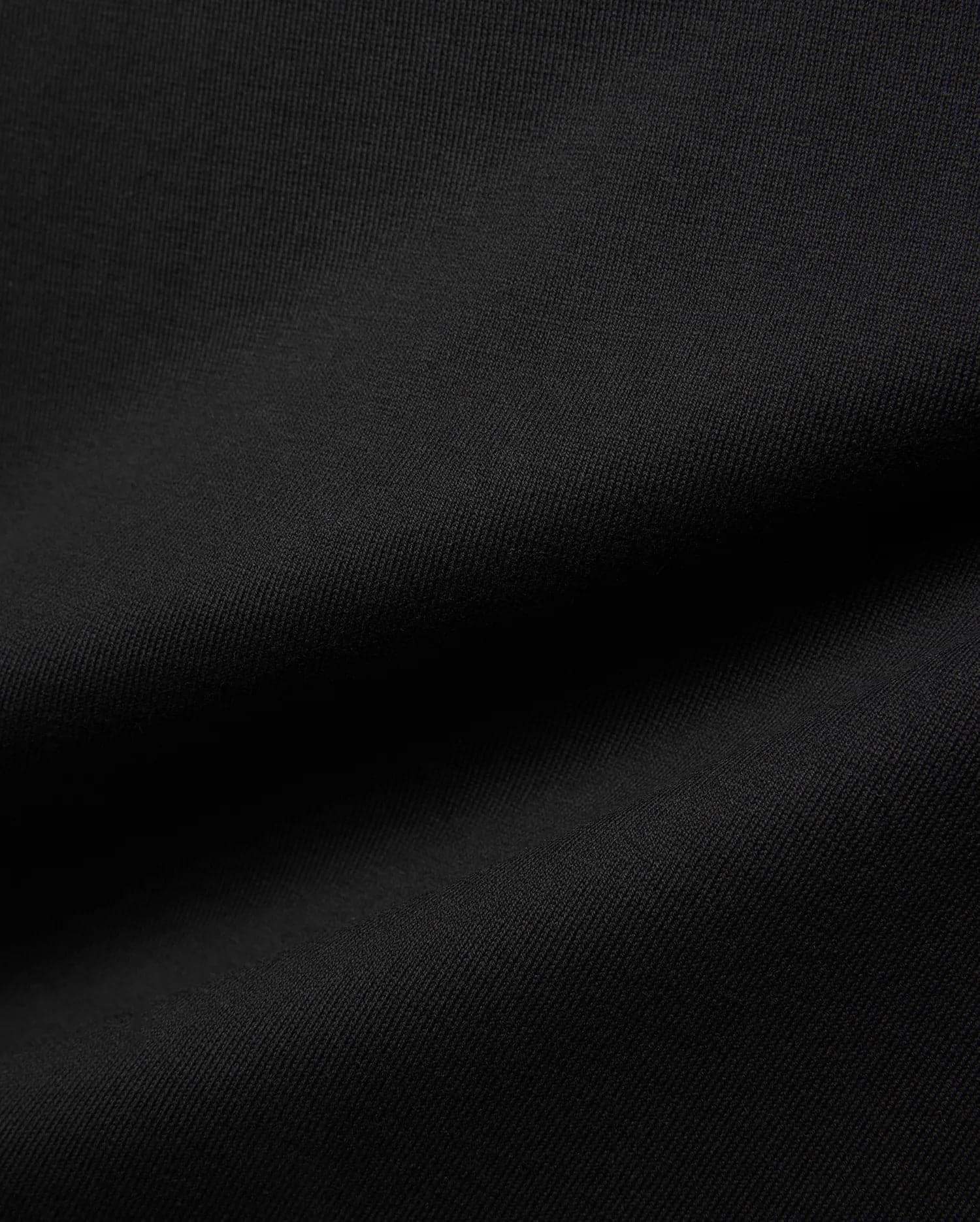 Mens Jaydon Relaxed Fit Tee in deep black, crafted from a premium, soft-touch jersey knit fabric with a subtle, refined texture, embodying Psycho Bunny's signature comfortable streetwear aesthetic.
