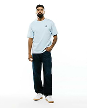 Mens Jaydon Pima Cotton Oversized-Fit Tee in light blue, featuring a soft jersey texture and a small, colorful embroidered Psycho Bunny skull logo on the left chest.