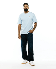 Mens Jaydon Pima Cotton Oversized-Fit Tee in light blue, featuring a soft jersey texture and a small, colorful embroidered Psycho Bunny skull logo on the left chest.