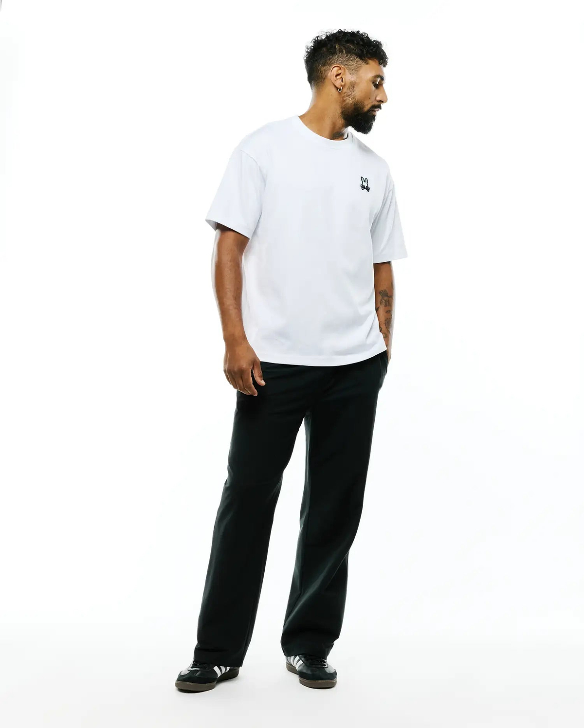 Mens Jaydon Pima Cotton Oversized-Fit Tee in white, featuring a smooth jersey texture and a small, embroidered navy Psycho Bunny skull logo on the left chest.