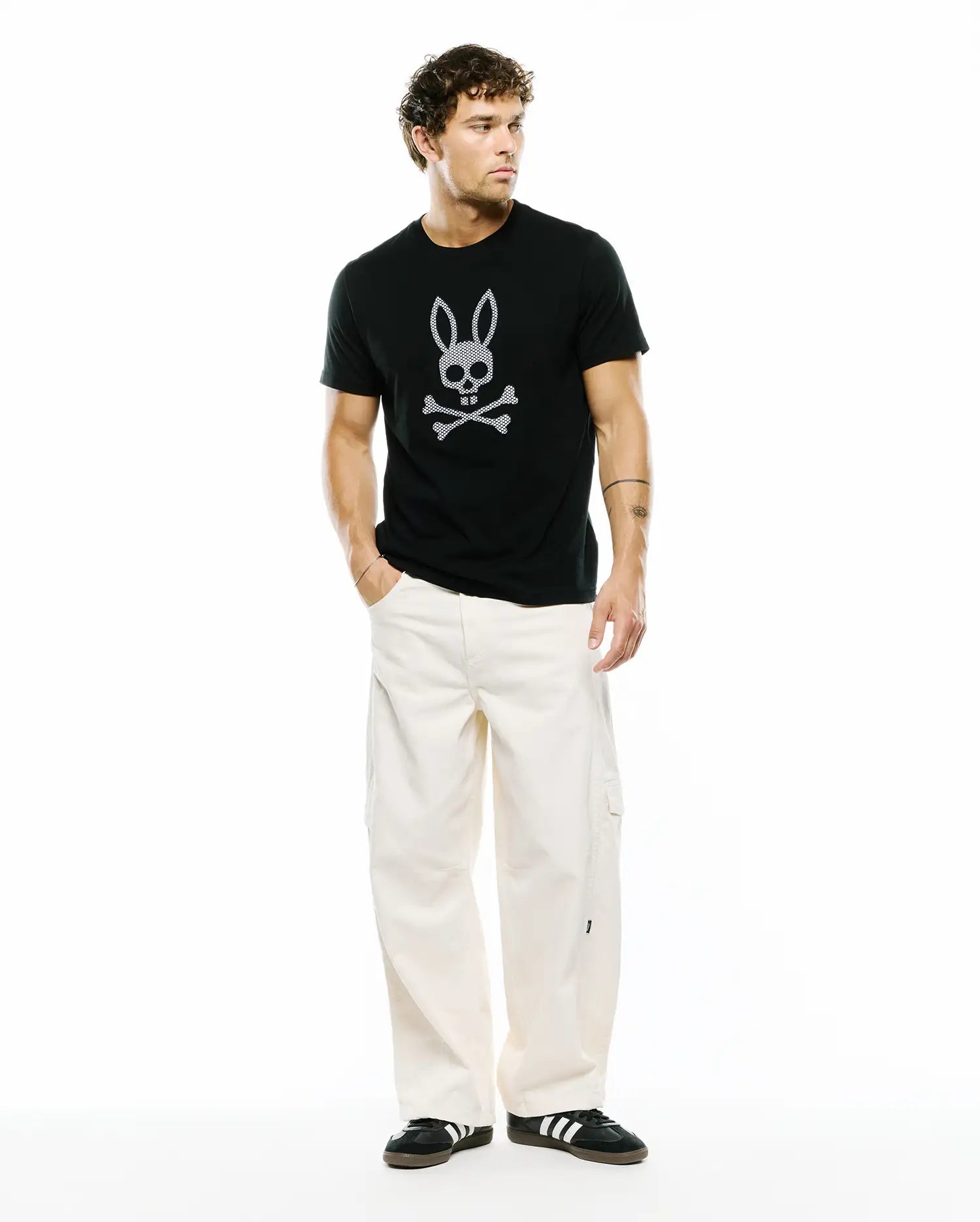 Mens Stan Graphic Tee, a black classic fit jersey t-shirt featuring a prominent white Psycho Bunny skull and crossbones graphic print on the center chest.