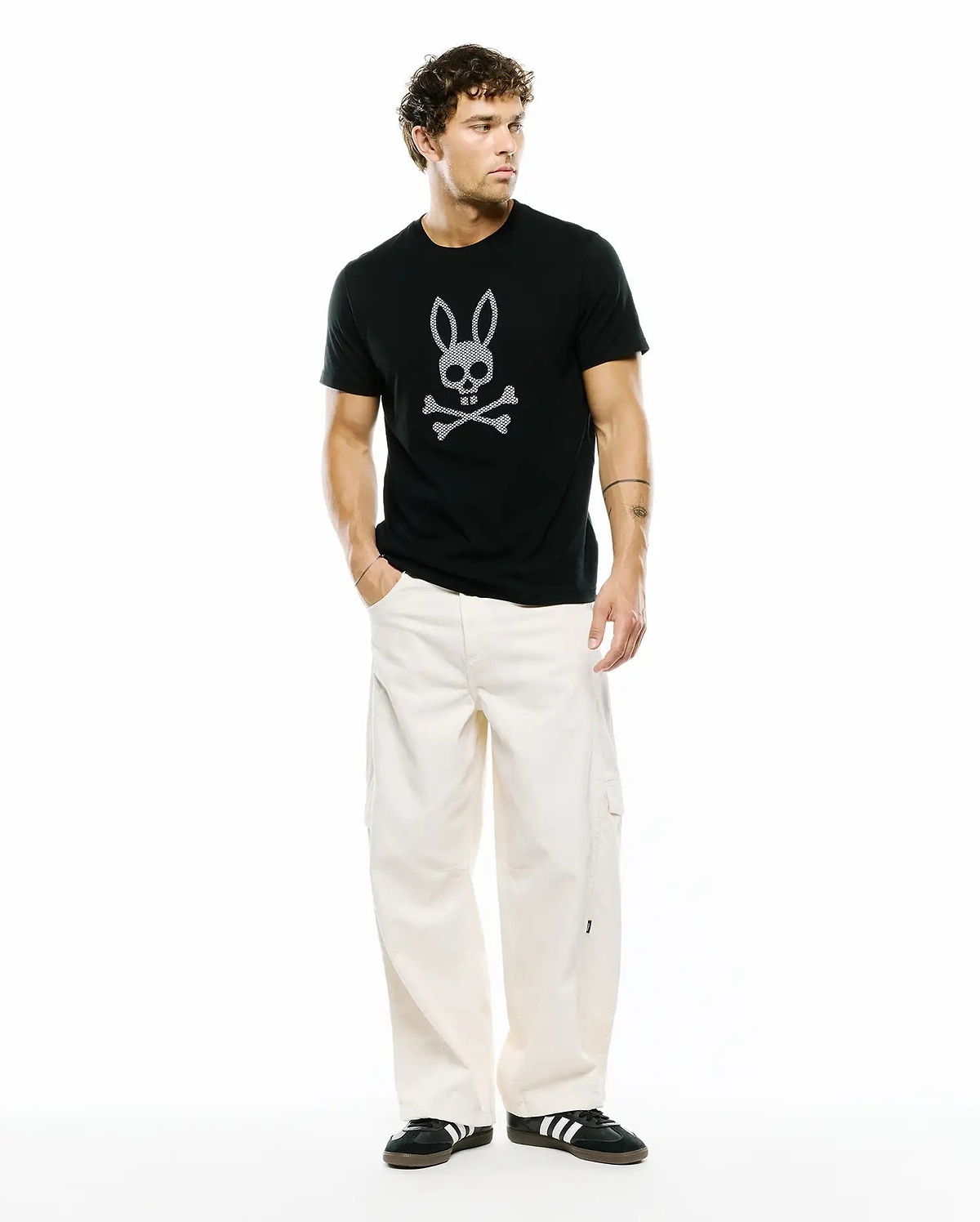 Mens Stan Graphic Tee, a black classic fit jersey t-shirt featuring a prominent white Psycho Bunny skull and crossbones graphic print on the center chest.