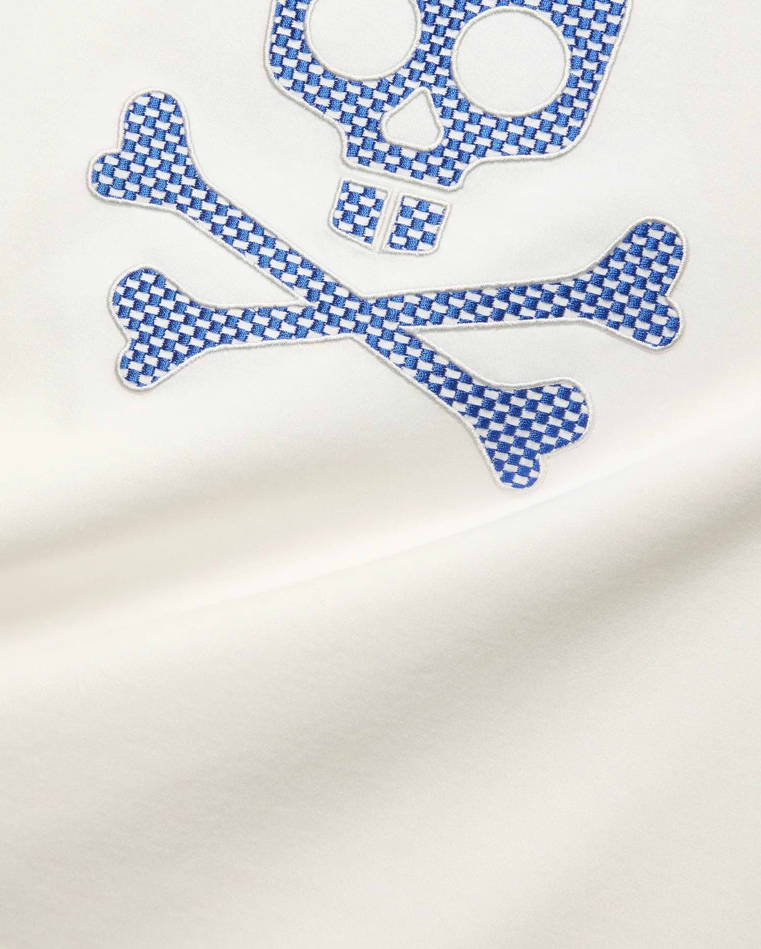 Mens Stan Graphic Tee in white smooth jersey, featuring a large embroidered Psycho Bunny skull and crossbones logo with a blue and white checkerboard pattern.