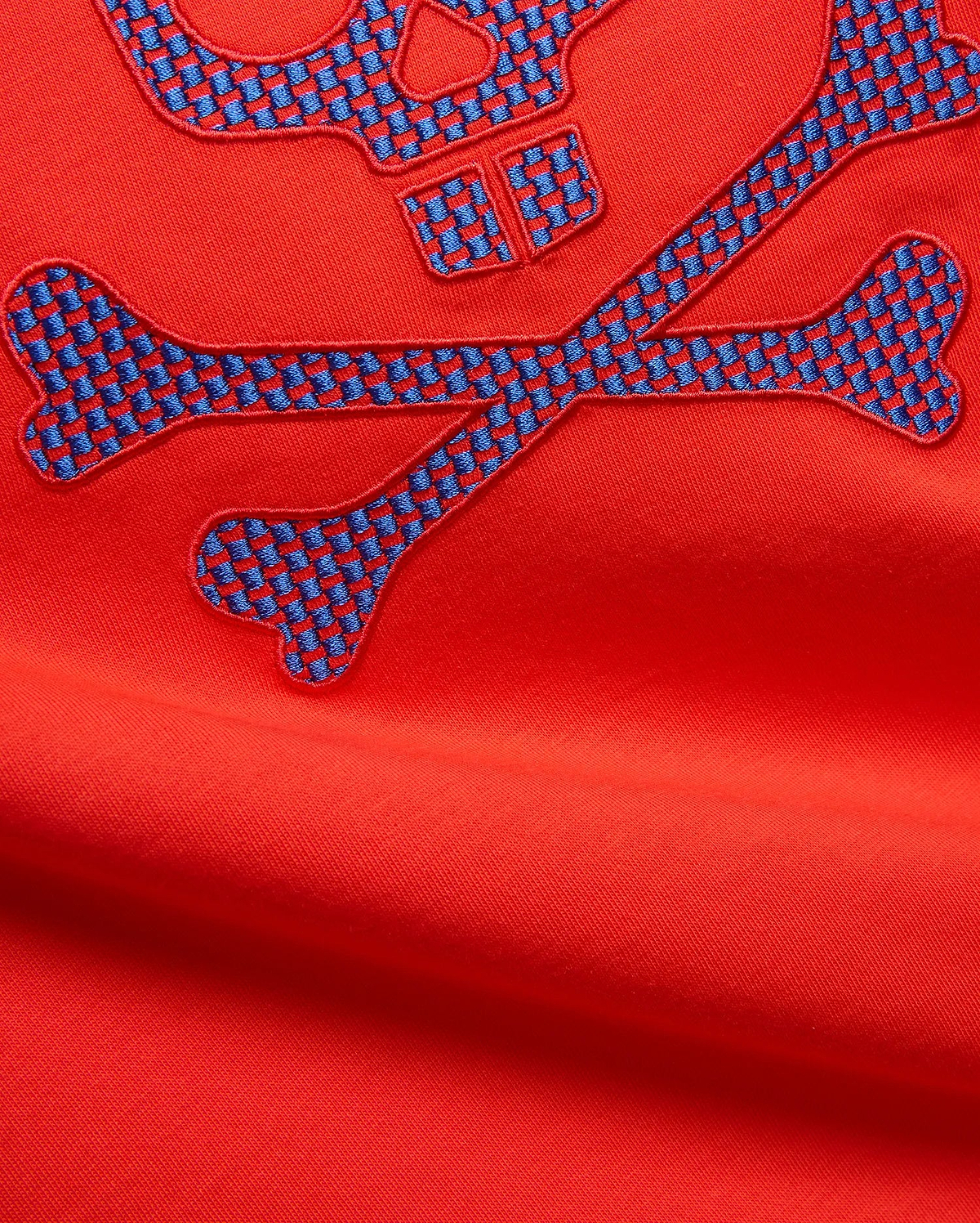 Mens Stan Graphic Tee in vibrant red jersey knit, featuring a large embroidered bunny skull and crossbones logo with a blue and red checkered pattern.