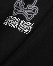 Mens Alex Relaxed Back Graphic Tee in black jersey knit, featuring a large white dotted outline bunny skull and repeated Psycho Bunny text graphic on the back.