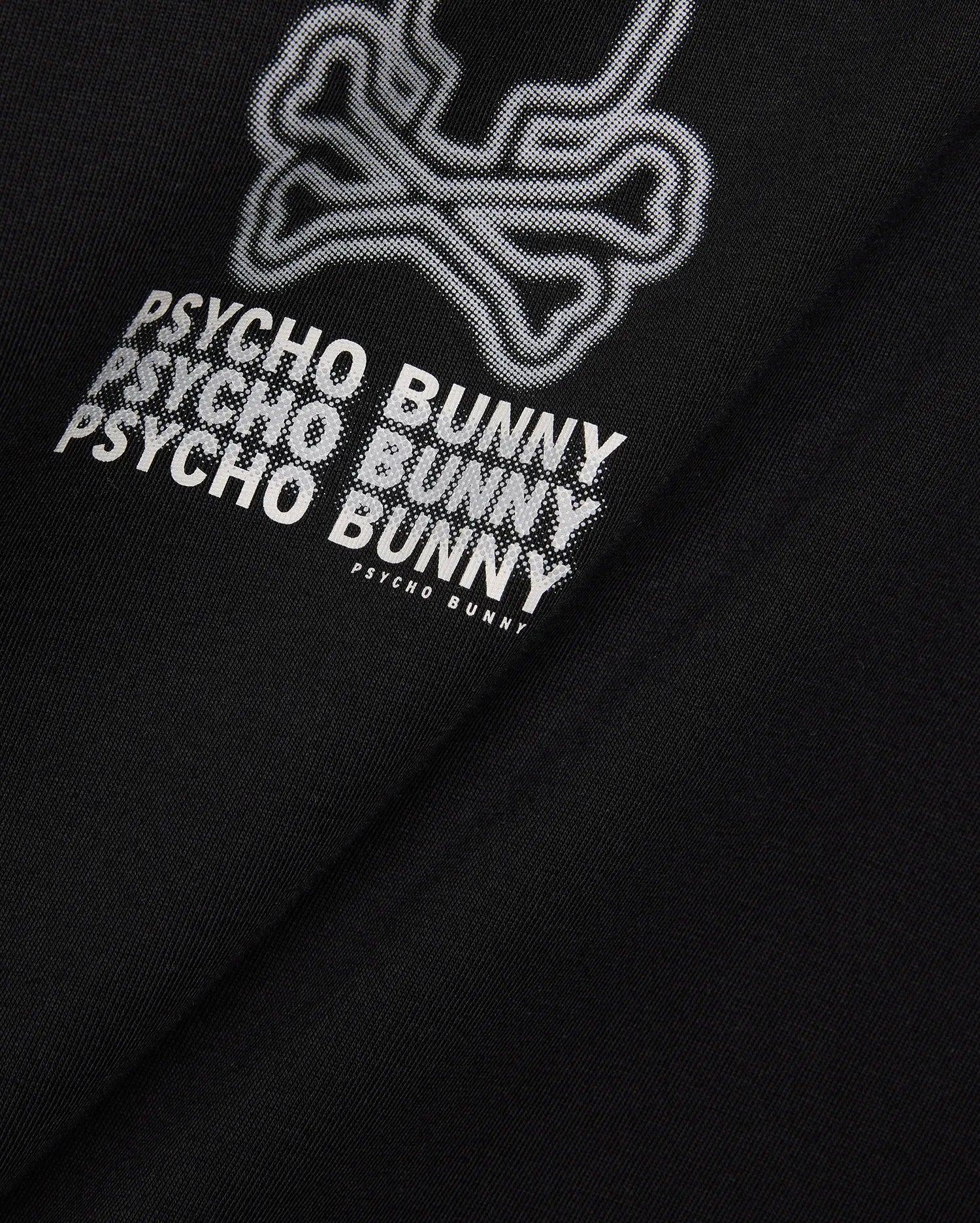 Mens Alex Relaxed Back Graphic Tee in black jersey knit, featuring a large white dotted outline bunny skull and repeated Psycho Bunny text graphic on the back.