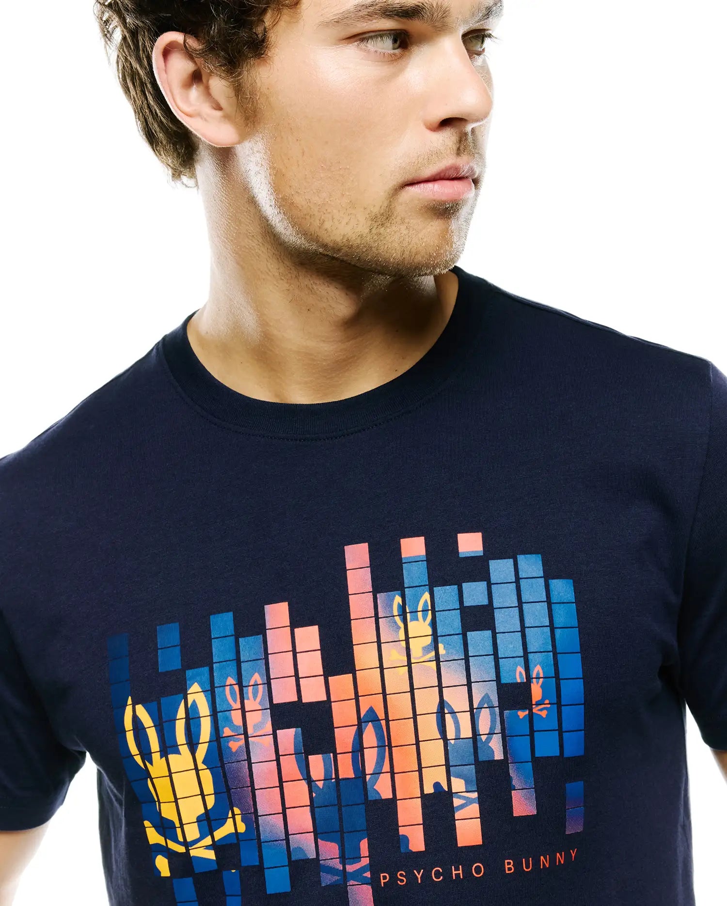 Mens Zander Graphic Tee, navy blue classic fit jersey knit t-shirt with a large pixelated chest graphic featuring gradient orange, blue, and yellow bunny skull logos and Psycho Bunny text.