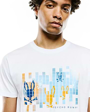 Mens Zander Graphic Tee, a white jersey t-shirt with a large chest graphic featuring pixelated blue, orange, and light blue Psycho Bunny skull logos and PSYCHO BUNNY text, classic fit.