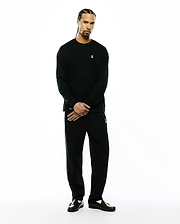 Black Mens Norman Long Sleeve Oversized Fit Tee with small white embroidered bunny skull on chest, and black relaxed track pants with white side stripes and an embroidered bunny skull on left thigh.