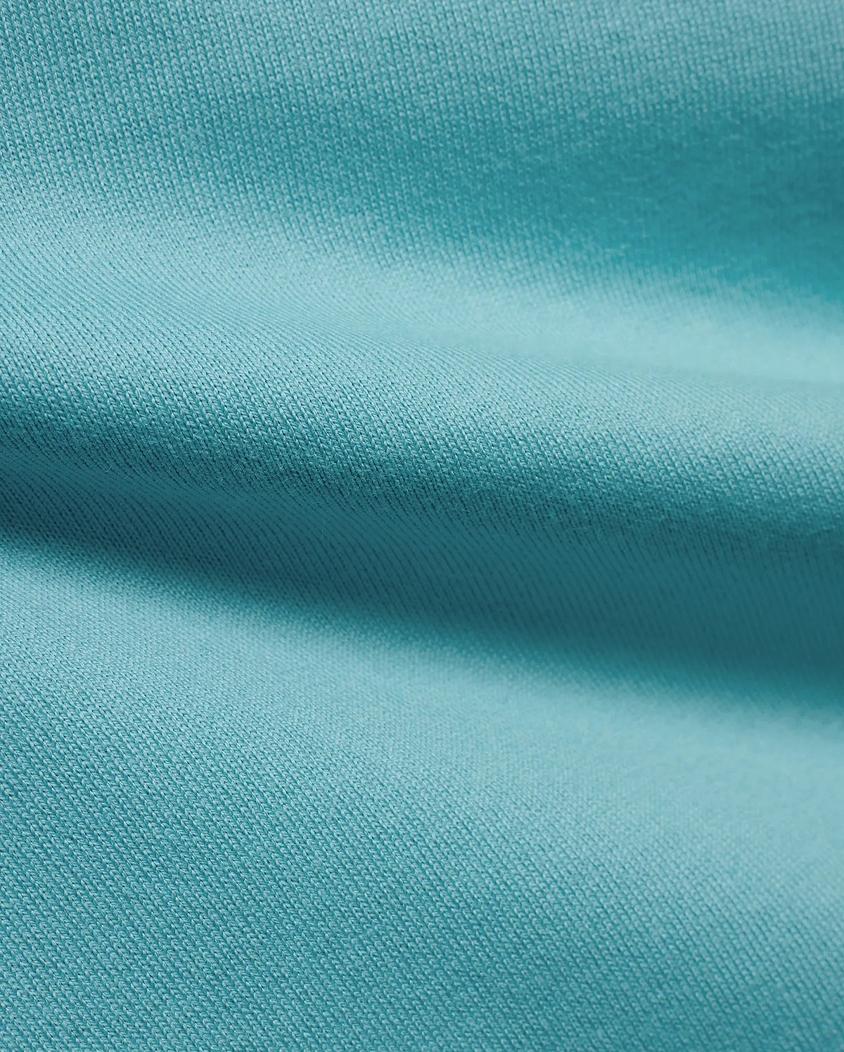 Men's Norman Longsleeve Oversized Tee in a vibrant aqua hue, highlighting the premium, soft jersey knit fabric with a smooth, comfortable texture and subtle draping. (6)