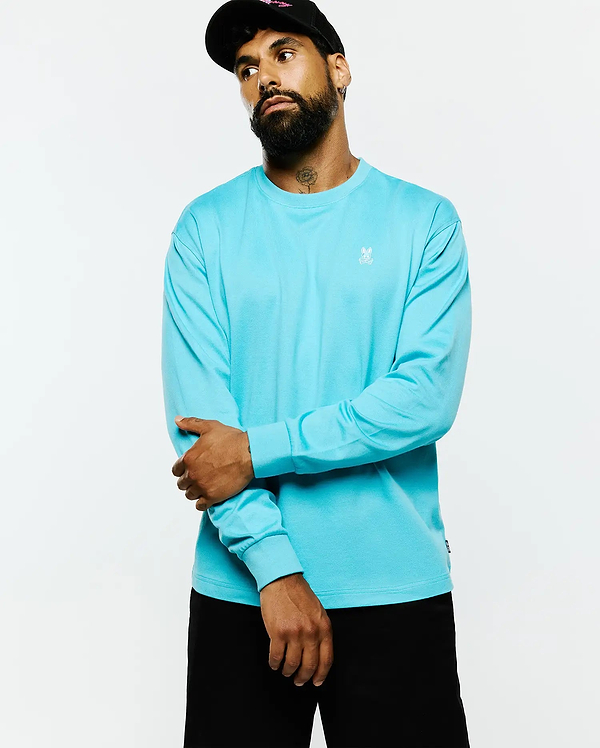 Mens Norman Long Sleeve Relaxed Fit Tee in aqua blue, featuring a smooth jersey knit fabric and a small white embroidered Psycho Bunny skull logo on the left chest.