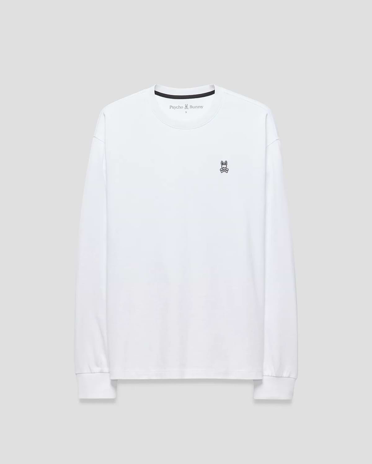 Mens Norman Long Sleeve Oversized Fit Tee in white smooth jersey, featuring a black crew neck tape with Psycho Bunny text and a small embroidered purple and black bunny skull logo on the left chest.