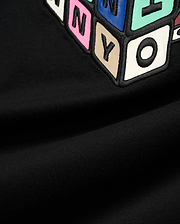 Mens Eddy Graphic Tee, black jersey t-shirt featuring a large, central, raised graphic of colorful block letters with black outlines, including pink N, blue Y, beige Y, and white O.