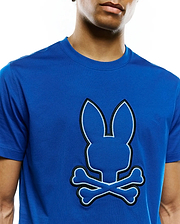 Mens Bruno Graphic Tee, a vibrant royal blue jersey t-shirt with a large, central tone-on-tone Psycho Bunny skull logo outlined in black embroidery and white stitching, featuring a classic fit.