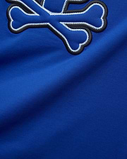 Royal blue Mens Bruno Graphic Tee in soft jersey, featuring a large embroidered Psycho Bunny skull logo with black outline and intricate white chain stitching.