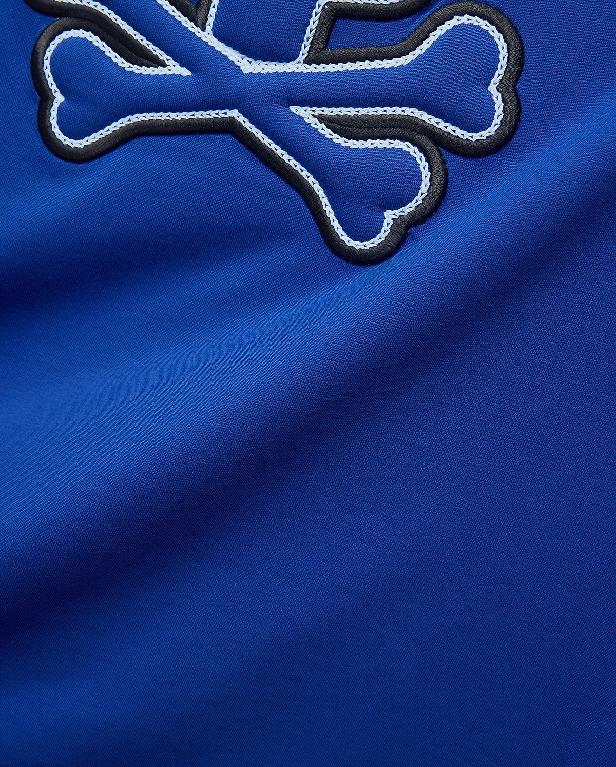 Royal blue Mens Bruno Graphic Tee in soft jersey, featuring a large embroidered Psycho Bunny skull logo with black outline and intricate white chain stitching.