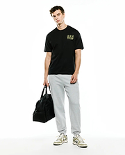 Men's Nathaniel Oversized Pima Tee, black Pima cotton jersey with a small, embroidered yellow/lime green Psycho Bunny logo featuring three bunny skulls and New York Since 2005 text on the left chest.