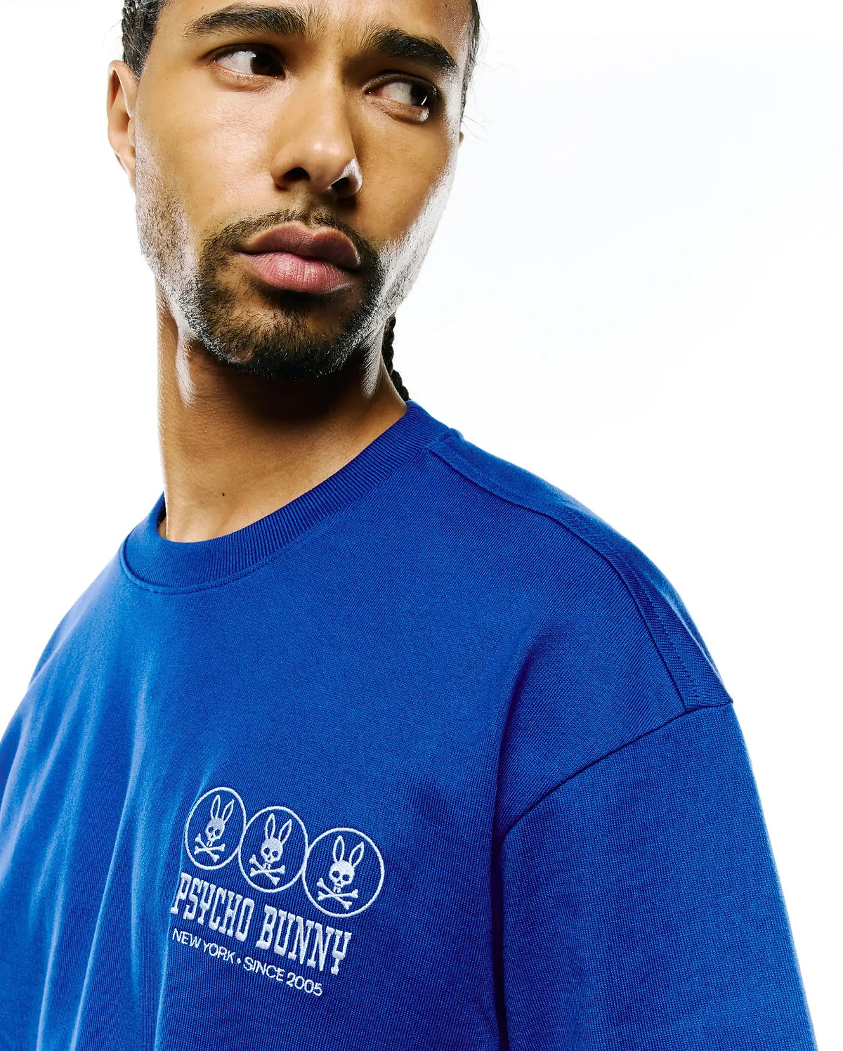 Royal blue Mens Nathaniel Relaxed Fit Tee in soft jersey knit, featuring a white embroidered left chest logo with three Psycho Bunny skull emblems and New York Since 2005 text.