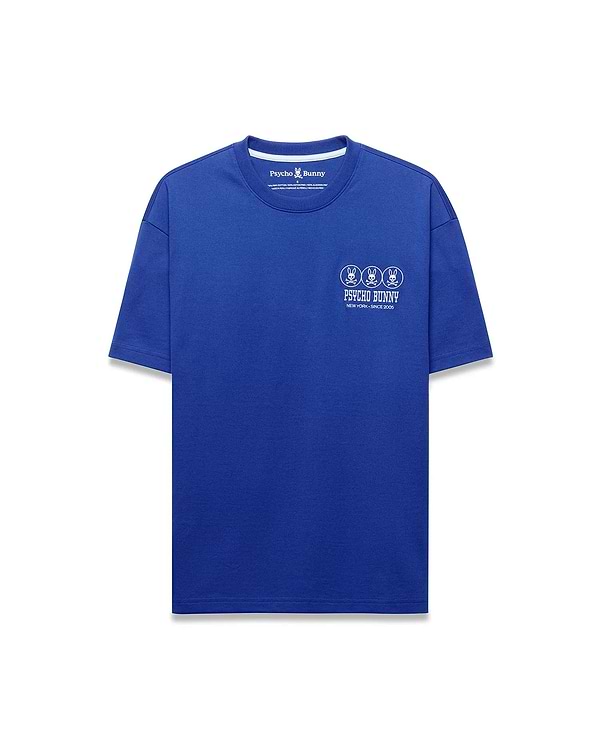 Mens Nathaniel Relaxed Fit Tee, a vibrant royal blue jersey t-shirt with a white center chest graphic featuring three Psycho Bunny skull logos, brand name, and New York Since 2005 text.