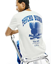 Mens Nathaniel Back Graphic Tee, a classic fit white jersey t-shirt featuring a large blue Psycho Bunny text and striped bunny skull logo graphic on the back, with New York Since 2005 branding.