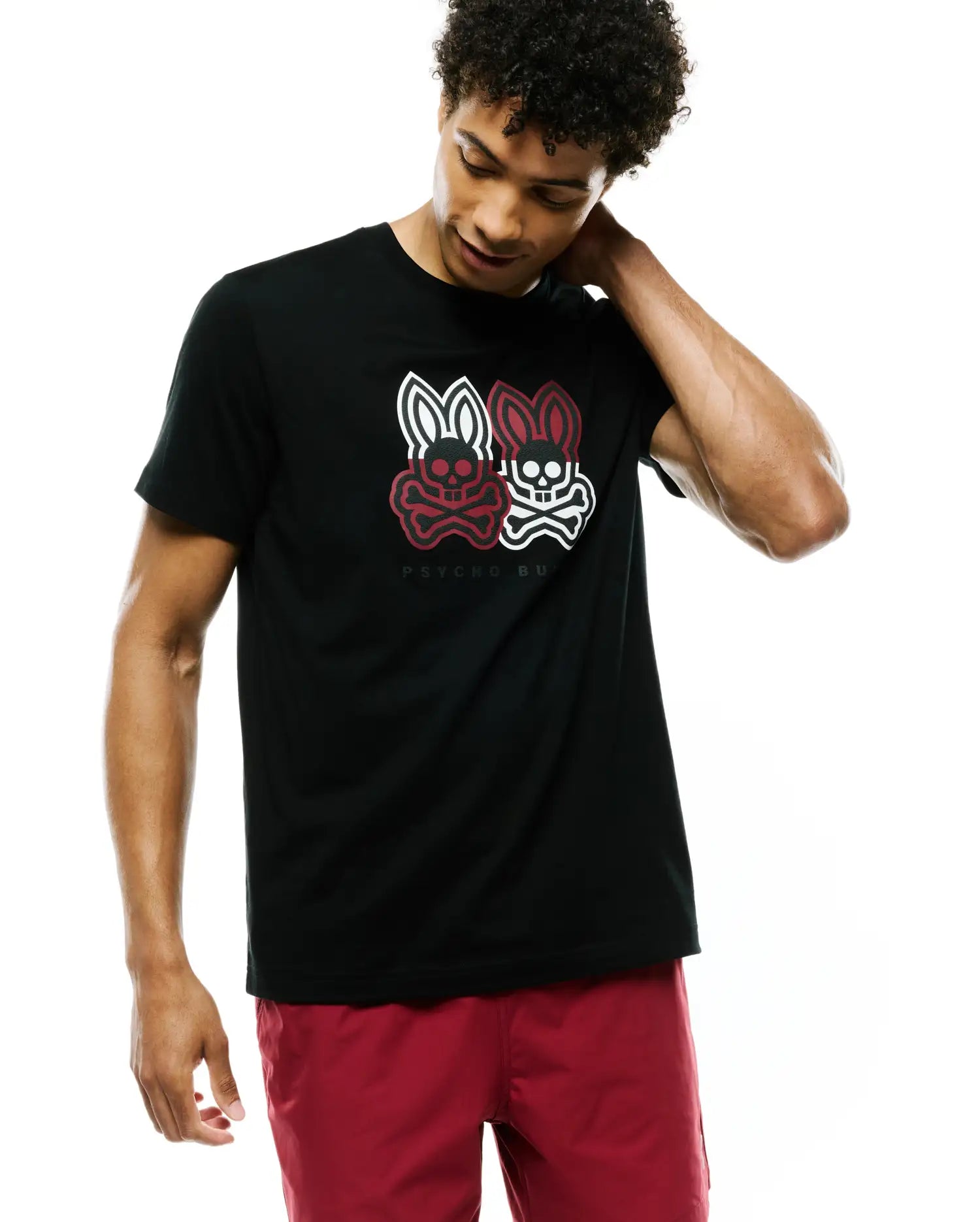 Mens Ledger Graphic Tee, black jersey knit t-shirt with a classic fit, featuring a large central chest graphic of two Psycho Bunny skull logos, one white and one red, with PSYCHO BUNNY text below.