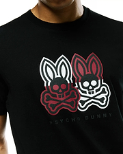Mens Ledger Graphic Tee, a black jersey knit t-shirt with a classic fit, featuring a large textured chest graphic of two Psycho Bunny skull logos, one red and black, one white and black, with Psycho Bunny text below.