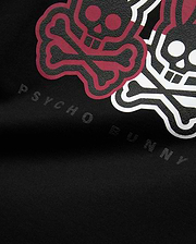 Mens Ledger Graphic Tee in black jersey knit, featuring a large, raised, textured graphic of maroon and white bunny skulls and crossbones, with subtle embossed Psycho Bunny text below.