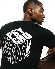 Men's Conan Pima Back Graphic Tee, a black classic fit Pima cotton jersey t-shirt featuring a large white 3D-effect Psycho Bunny text graphic and iconic bunny skull logo on the back.