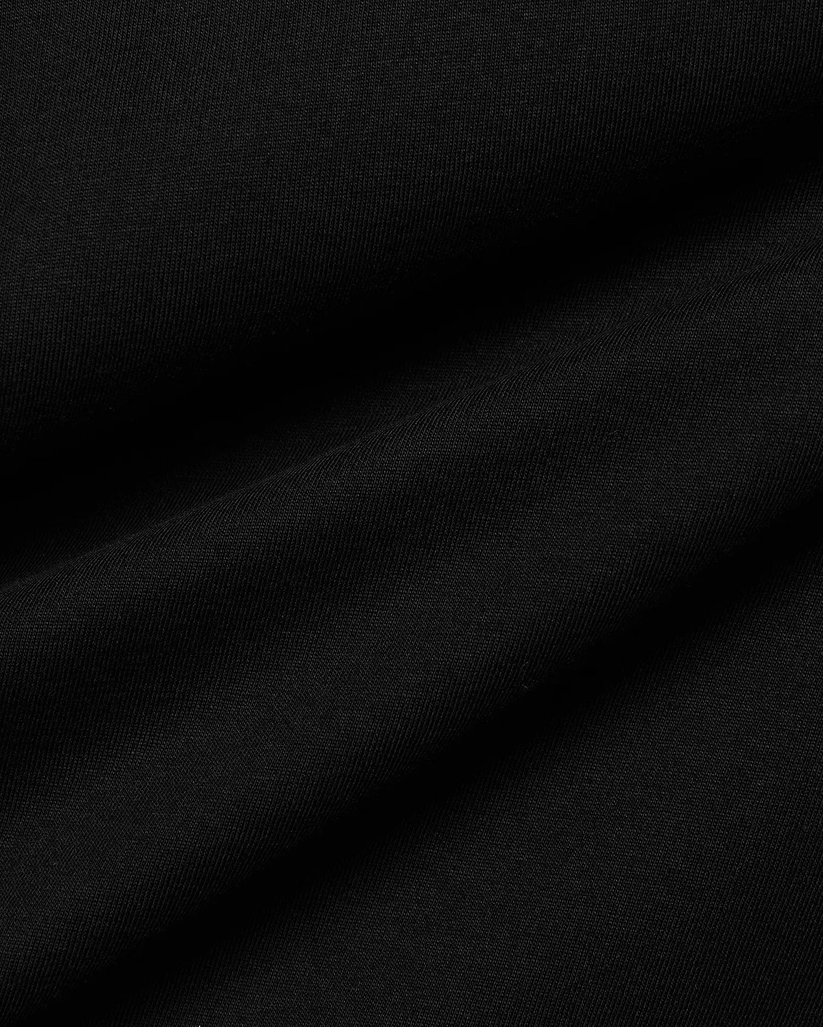 Men's Conan Pima Back Graphic Tee, a premium black Pima cotton jersey fabric, showcasing its fine, soft texture and subtle diagonal ribbing from the knit, with gentle folds.