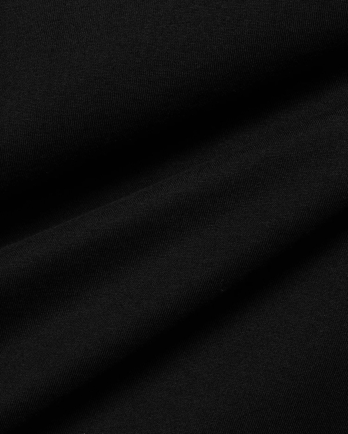 Men's Conan Pima Back Graphic Tee, a premium black Pima cotton jersey fabric, showcasing its fine, soft texture and subtle diagonal ribbing from the knit, with gentle folds.