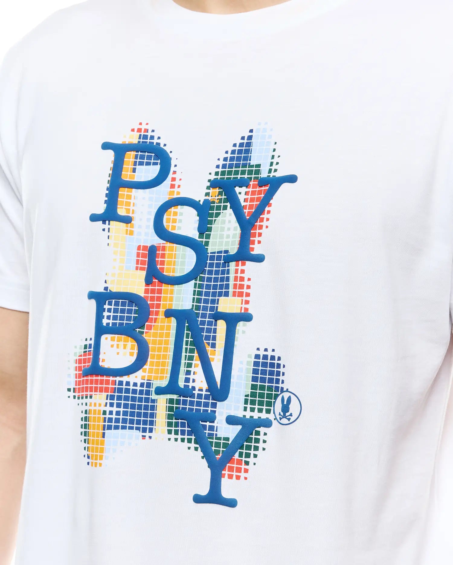 MENS WES GRAPHIC TEE. White jersey knit, classic fit. Features a large central raised blue PSYBNY graphic over a colorful pixelated grid background in red, yellow, green, and blue, with a small blue Psycho Bunny skull logo.