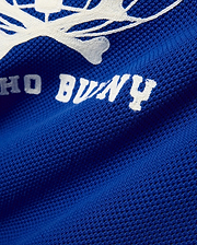 Mike Knit Graphic Jersey in royal blue, featuring a large white knit Psycho Bunny skull graphic and text on a breathable mesh fabric. (7)