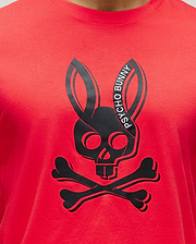 Mens Serge Embroidered Bunny Graphic Tee. A vibrant red classic fit jersey t-shirt featuring a large central black Psycho Bunny skull and crossbones graphic with white Psycho Bunny text.