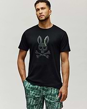 Mens Serge Embroidered Bunny Graphic Tee, black classic fit jersey knit with a large, centered dark grey embroidered Psycho Bunny skull and crossbones logo featuring lime green text.