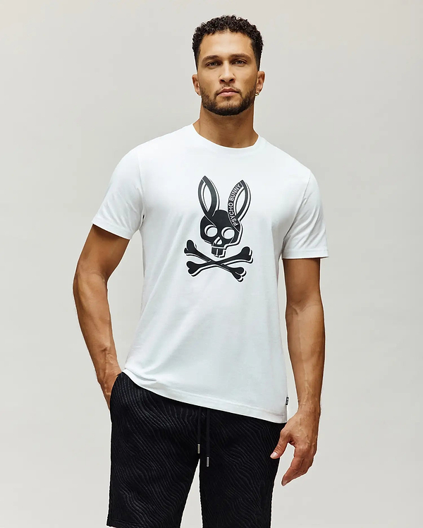Mens Serge Embroidered Bunny Graphic Tee, a white classic fit jersey t-shirt featuring a large black Psycho Bunny skull and crossbones graphic centered on the chest.