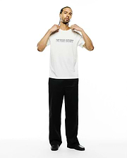 Mens Joji Wordmark Graphic Tee, a premium cream classic fit jersey t-shirt featuring a bold black outline PSYCHO BUNNY wordmark graphic prominently on the chest.