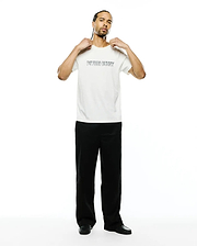 Mens Joji Wordmark Graphic Tee, a premium cream classic fit jersey t-shirt featuring a bold black outline PSYCHO BUNNY wordmark graphic prominently on the chest.