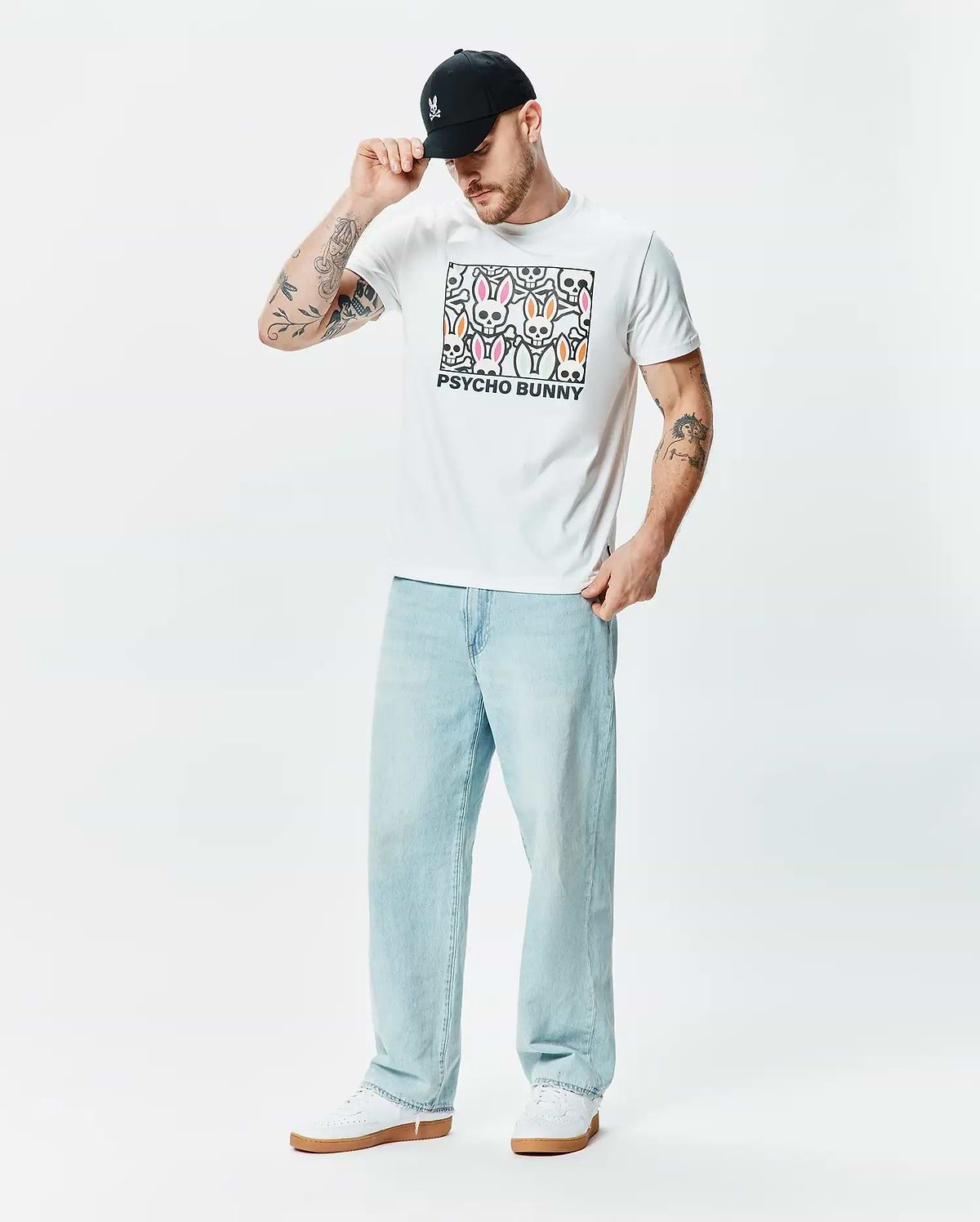 Mens Byron Graphic Tee, a white classic fit soft jersey t-shirt featuring a large chest graphic of colorful pink, green, and orange bunny skulls with PSYCHO BUNNY text. (5)