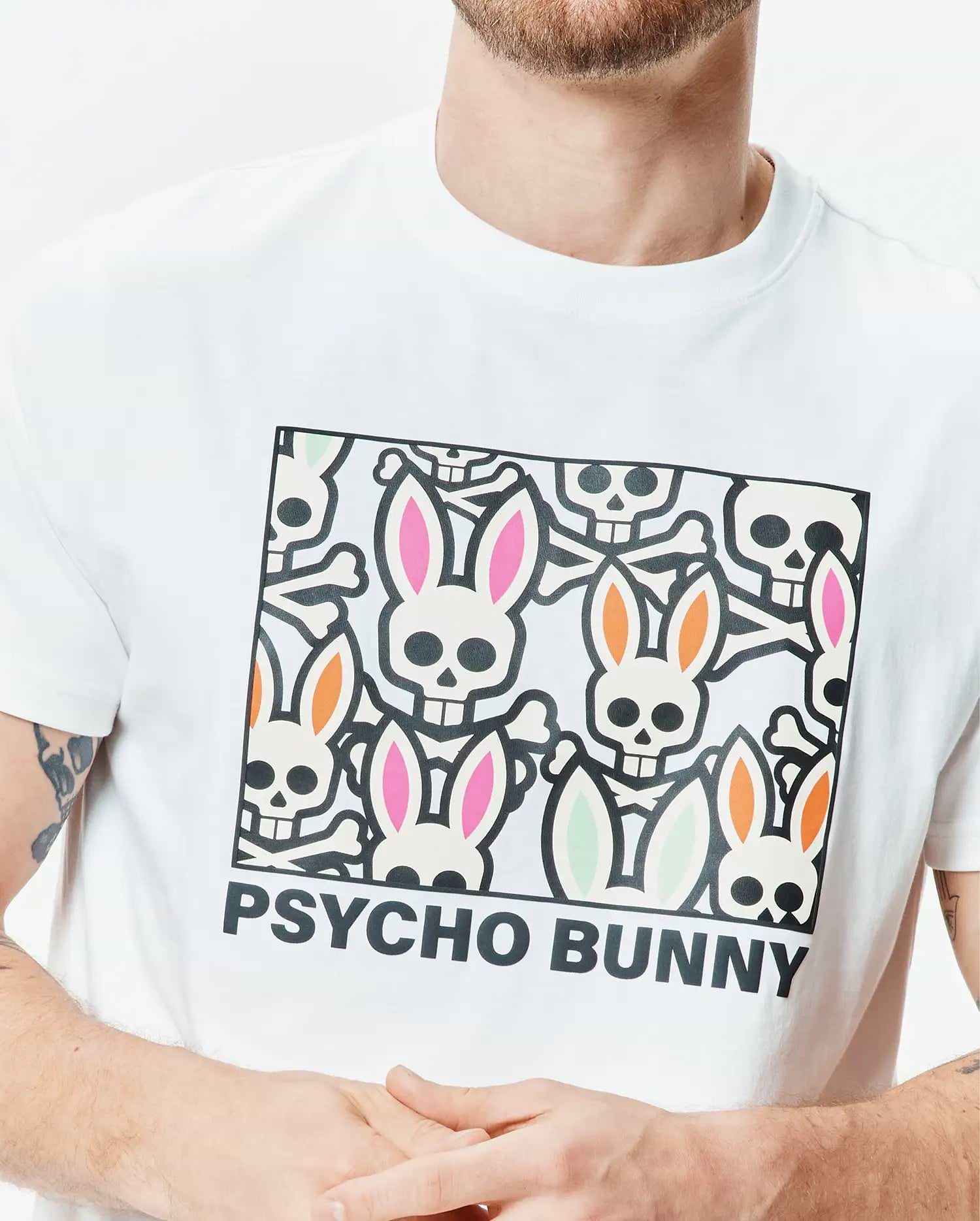 Mens Byron Graphic Tee, white classic fit jersey t-shirt with a large chest graphic of colorful bunny skulls, crossbones, and PSYCHO BUNNY text. (3)