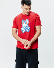 Mens John Graphic Tee, a classic fit red jersey t-shirt featuring a large white, light blue, and orange Psycho Bunny skull logo graphic centered on the chest.