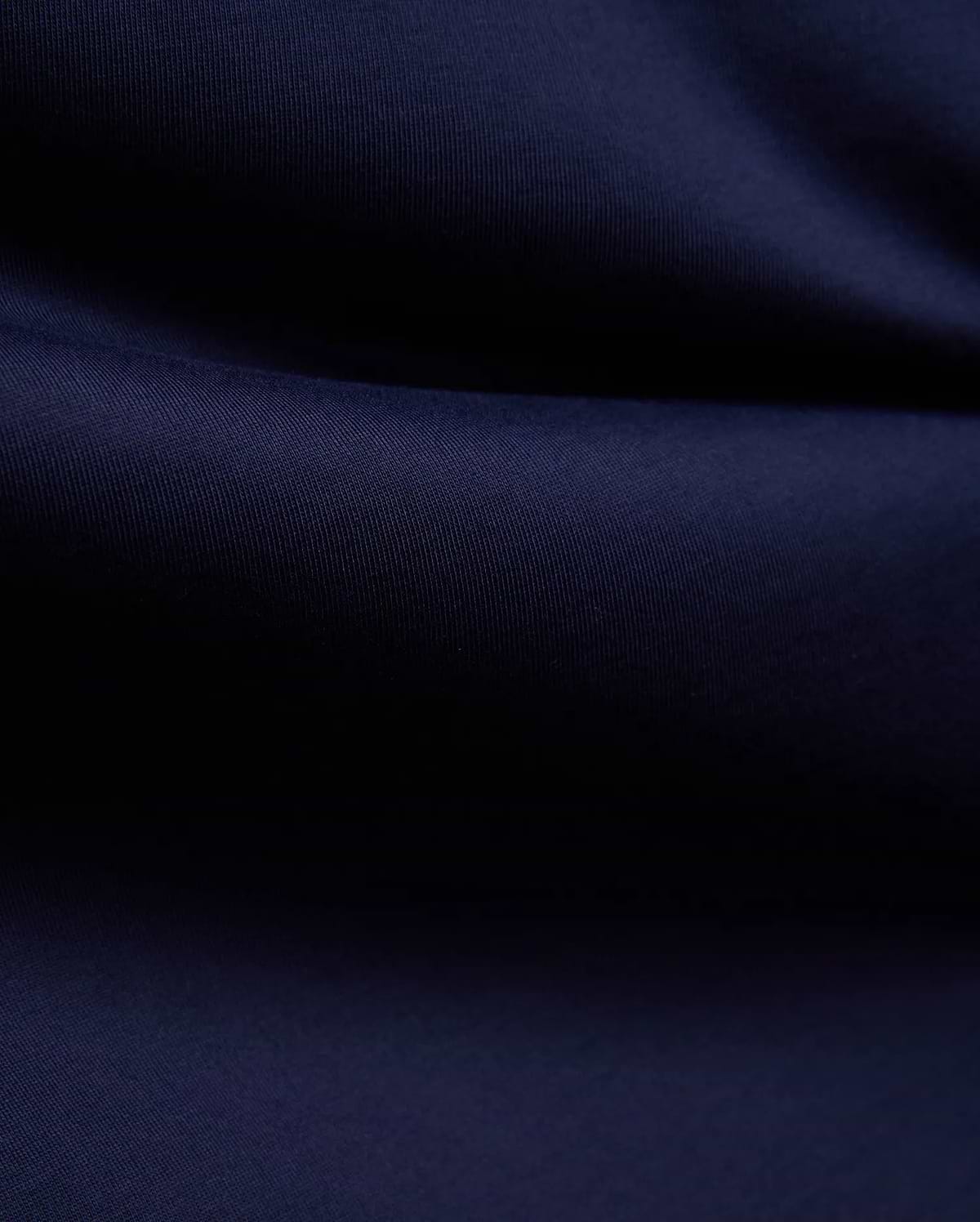 Mens John Graphic Tee, a premium Psycho Bunny dark navy blue t-shirt, showcasing its refined, soft, finely textured jersey knit fabric with elegant, flowing folds, perfect for refined streetwear.