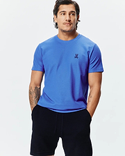 Mens Taylor Pique Tee, a vibrant royal blue classic fit t-shirt with a visible pique knit texture, featuring a small, embroidered dark blue Psycho Bunny skull logo on the left chest. (4)