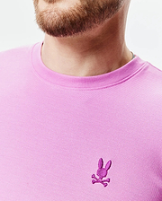 Mens Taylor Pique Tee in vibrant pink, classic fit, with a textured pique knit and a small, embroidered magenta Psycho Bunny skull logo on the left chest.