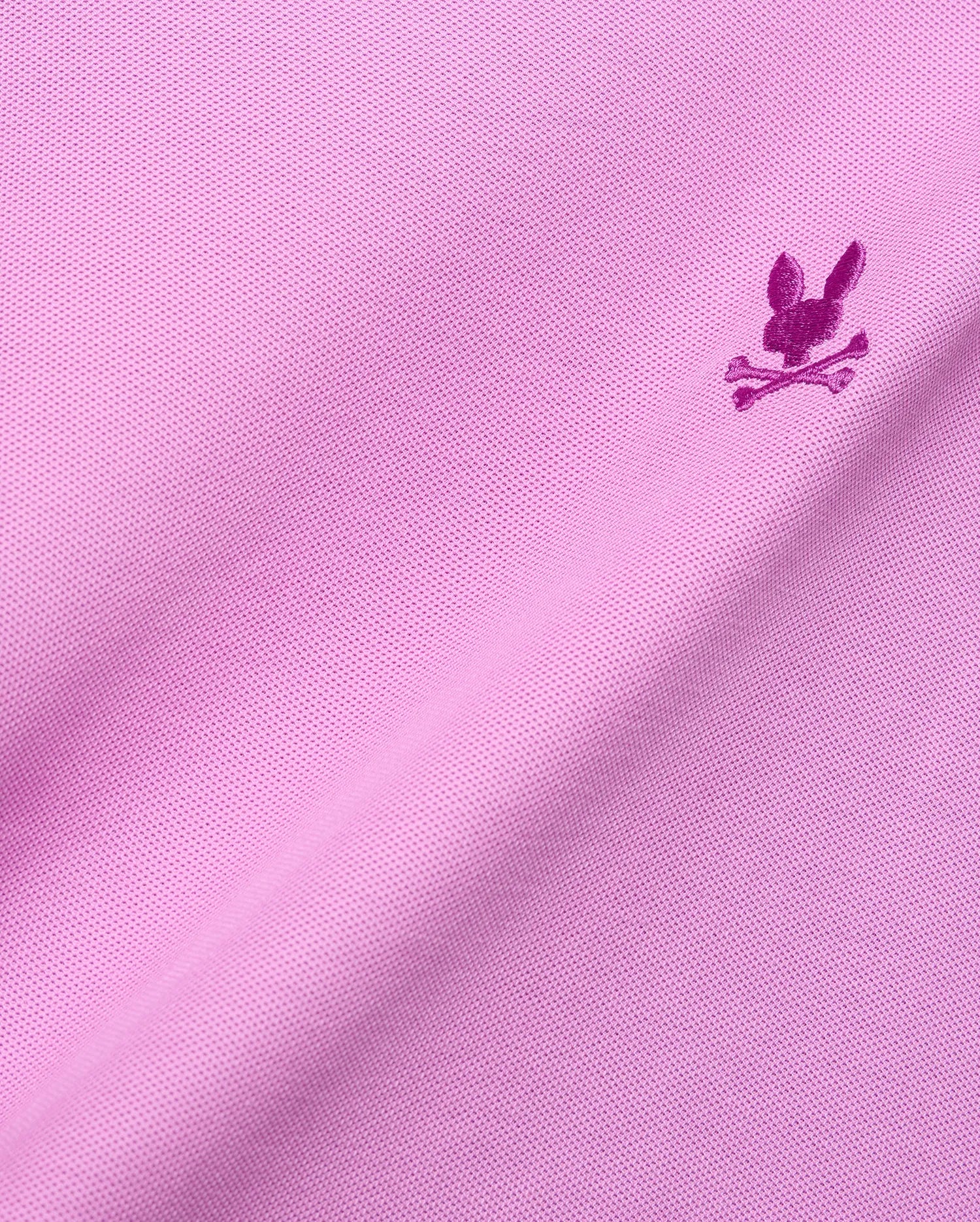 Vibrant pink Mens Taylor Pique Tee with classic pique knit texture and a small, embroidered magenta Psycho Bunny skull logo on the chest.