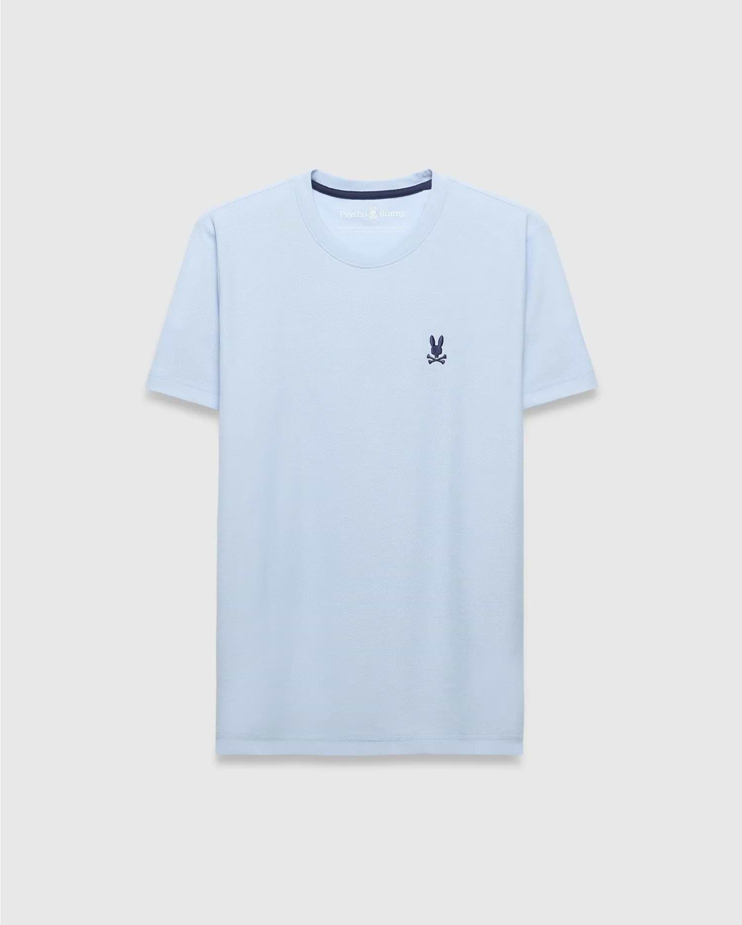 Mens Taylor Pique Tee, a light blue classic fit t-shirt with a pique texture, featuring a small embroidered navy Psycho Bunny skull logo on the left chest and navy inner collar trim.
