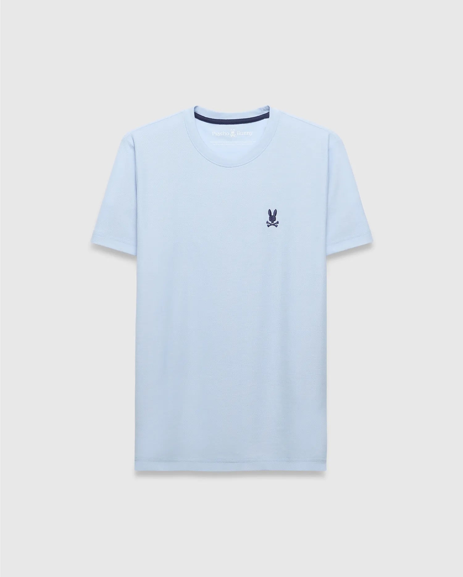 Mens Taylor Pique Tee, a light blue classic fit t-shirt with a pique texture, featuring a small embroidered navy Psycho Bunny skull logo on the left chest and navy inner collar trim.