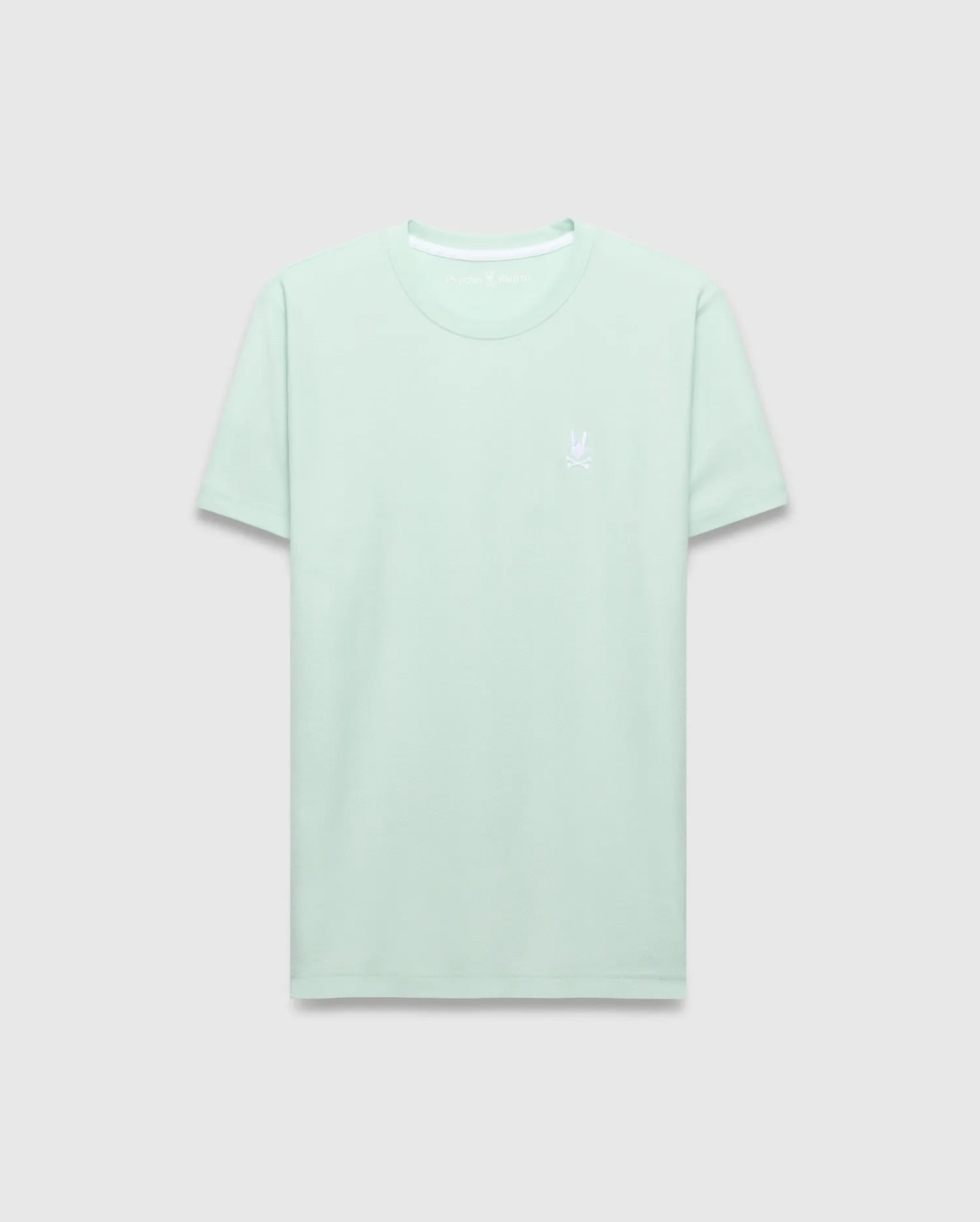 Mens Taylor Pique Tee, a classic fit mint green pique knit t-shirt with a small white embroidered Psycho Bunny skull logo on the left chest and white inner collar trim.
