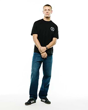 Mens Olek Relaxed Back Graphic Tee, a black relaxed fit soft jersey knit t-shirt featuring a small white circular Psycho Bunny skull logo with text on the left chest. (4)