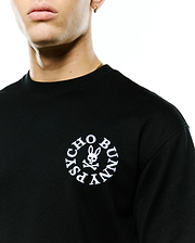 Mens Olek Relaxed Back Graphic Tee, black jersey knit with a relaxed fit, featuring a white embroidered circular Psycho Bunny skull and crossbones logo on the left chest. (2)